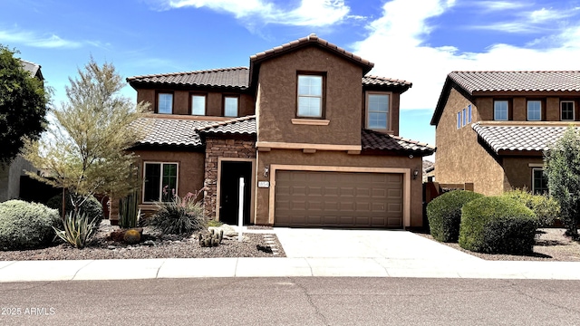 1854 W Fetlock Trl, Phoenix, AZ 85085 - view of front of home featuring stucco siding, a tile roof, concrete driveway, a garage, and stone siding