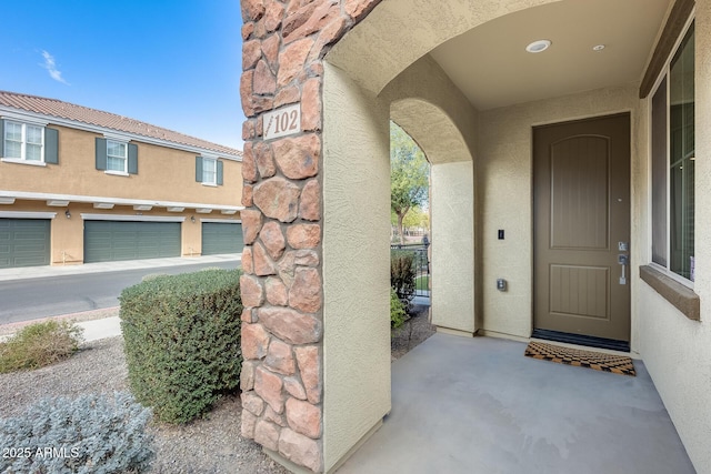 view of exterior entry featuring a garage