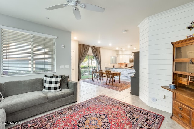 tiled living room featuring ceiling fan