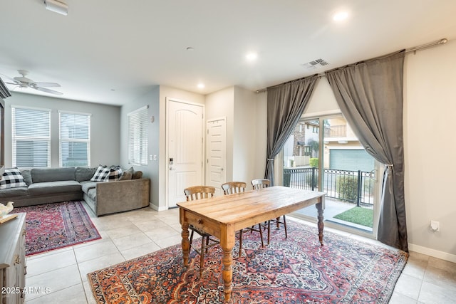 dining area featuring light tile patterned flooring, ceiling fan, and a healthy amount of sunlight