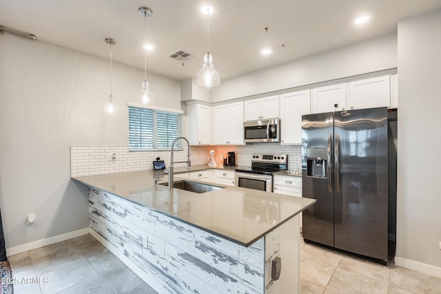 kitchen featuring white cabinetry, sink, stainless steel appliances, and kitchen peninsula