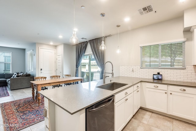 kitchen featuring sink, dishwasher, white cabinets, decorative light fixtures, and kitchen peninsula