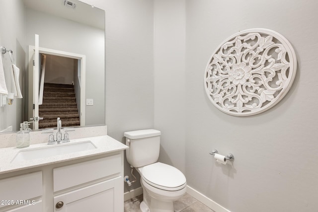 bathroom with vanity, tile patterned flooring, and toilet