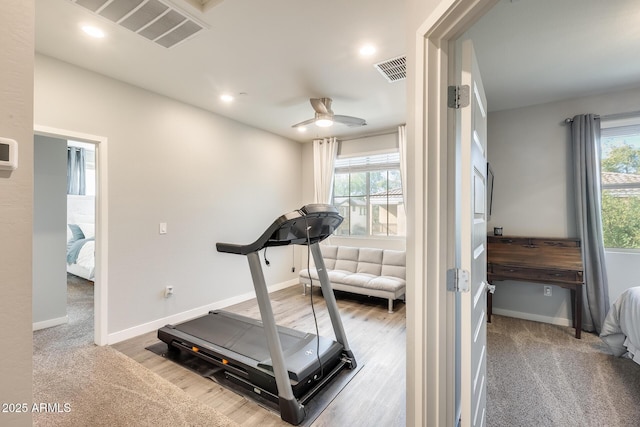 workout room with carpet and ceiling fan