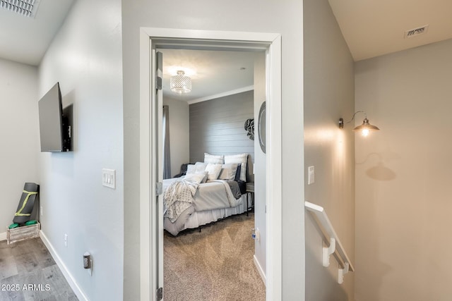 carpeted bedroom featuring crown molding