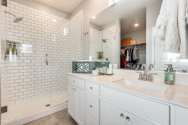 bathroom featuring vanity and an enclosed shower