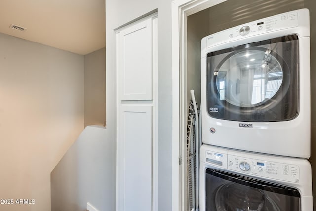 laundry room featuring stacked washer and dryer