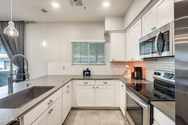 kitchen featuring appliances with stainless steel finishes, sink, and white cabinets