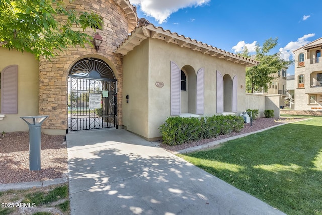 property entrance with a lawn