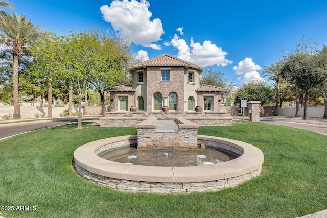 mediterranean / spanish-style house featuring a front lawn