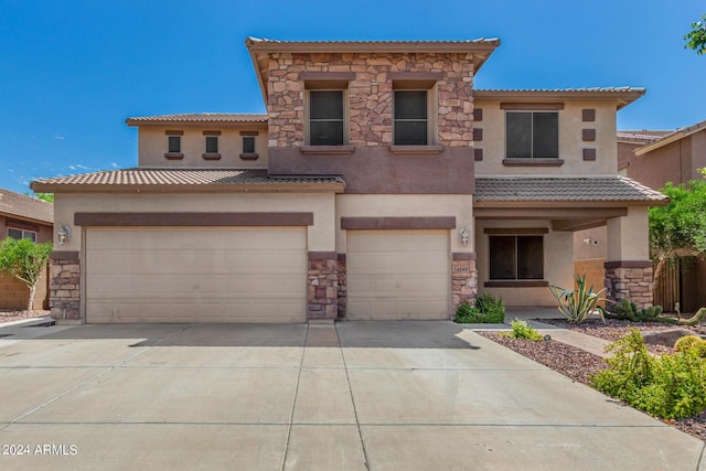 mediterranean / spanish house with stone siding, a tile roof, and stucco siding