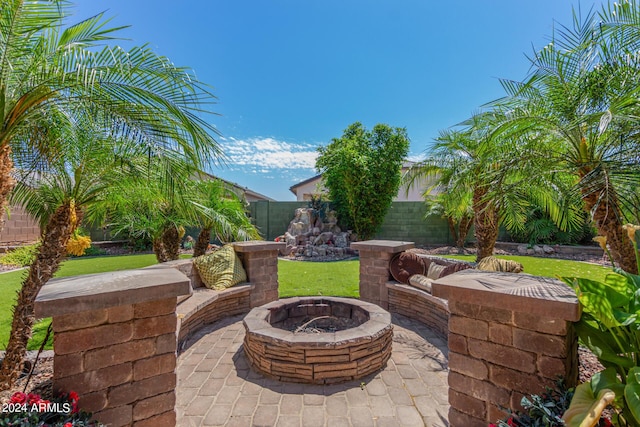 view of patio / terrace with an outdoor fire pit and a fenced backyard