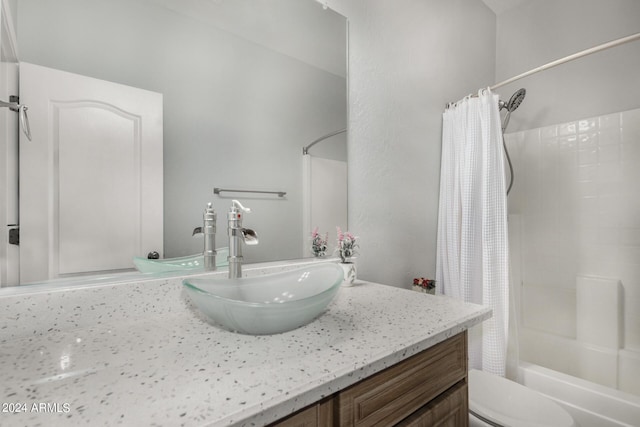 bathroom with toilet, shower / tub combo with curtain, and vanity