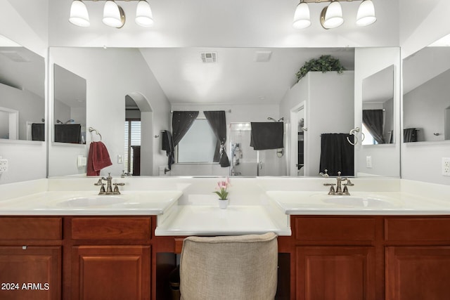 full bath featuring double vanity, visible vents, a sink, and walk in shower