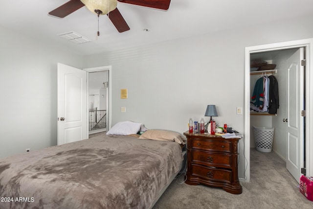 bedroom featuring visible vents, light colored carpet, ceiling fan, a spacious closet, and a closet