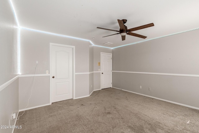 unfurnished room featuring visible vents, baseboards, a ceiling fan, and light colored carpet