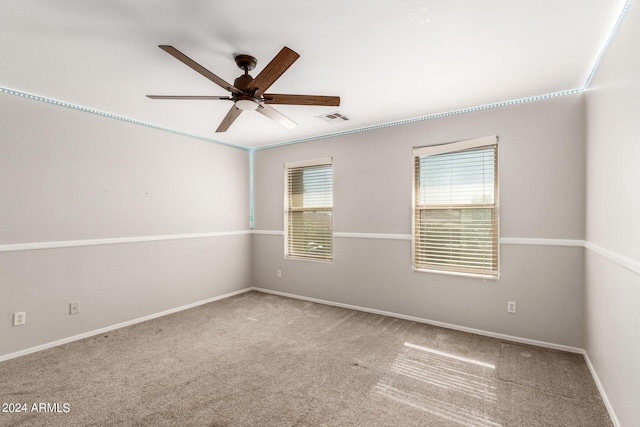 spare room with baseboards, ceiling fan, visible vents, and carpet flooring