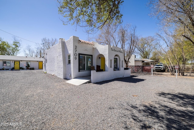 2709 E Willetta St, Phoenix, AZ 85008 - rear view of house with stucco siding, fence, and a tile roof