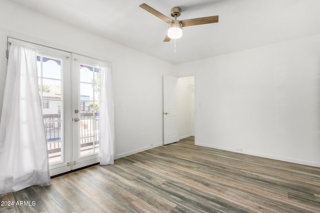 unfurnished room featuring french doors, wood-type flooring, and ceiling fan