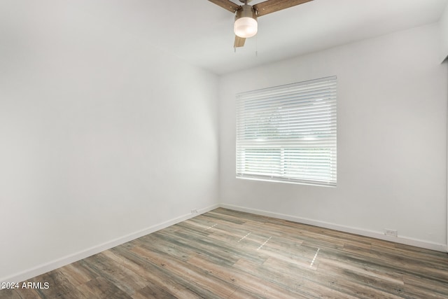 unfurnished room with hardwood / wood-style flooring and ceiling fan