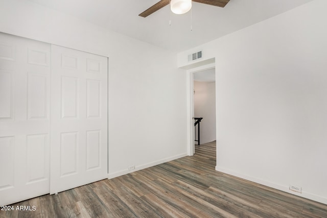 unfurnished bedroom with a closet, ceiling fan, and dark hardwood / wood-style floors