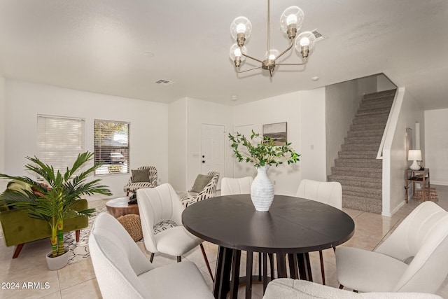 dining space featuring light tile patterned floors and an inviting chandelier