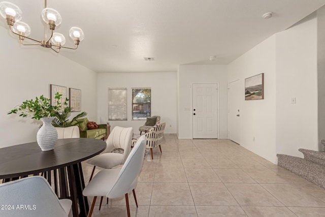 tiled dining area with an inviting chandelier