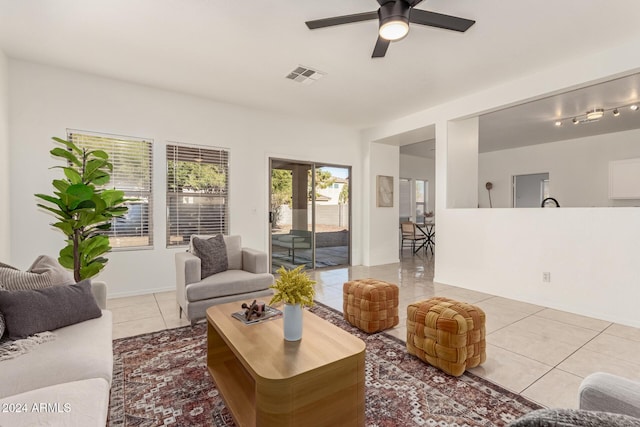 living room featuring light tile patterned floors and ceiling fan