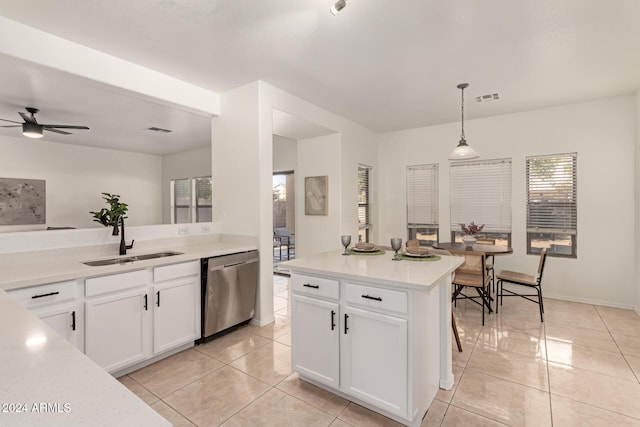 kitchen featuring white cabinets, sink, hanging light fixtures, stainless steel dishwasher, and ceiling fan