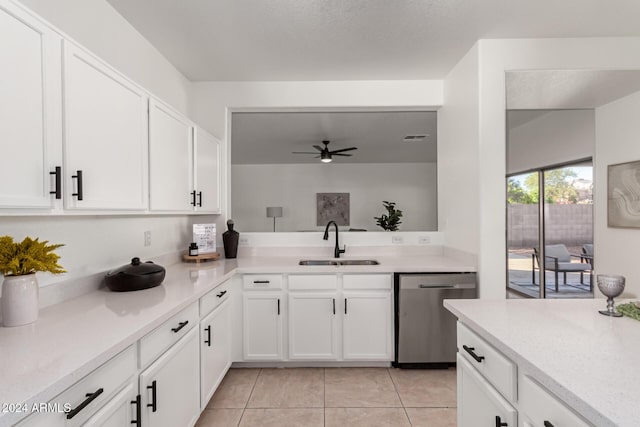 kitchen featuring stainless steel dishwasher, white cabinetry, and sink