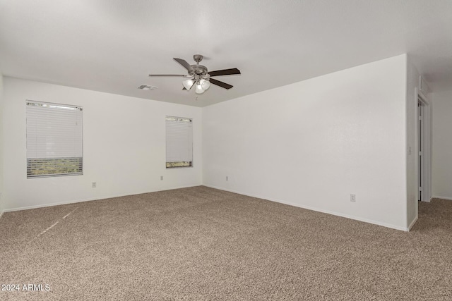 empty room featuring carpet floors and ceiling fan