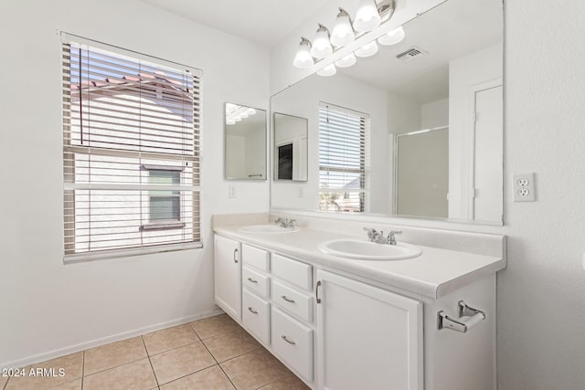 bathroom featuring vanity, tile patterned floors, and a shower with shower door