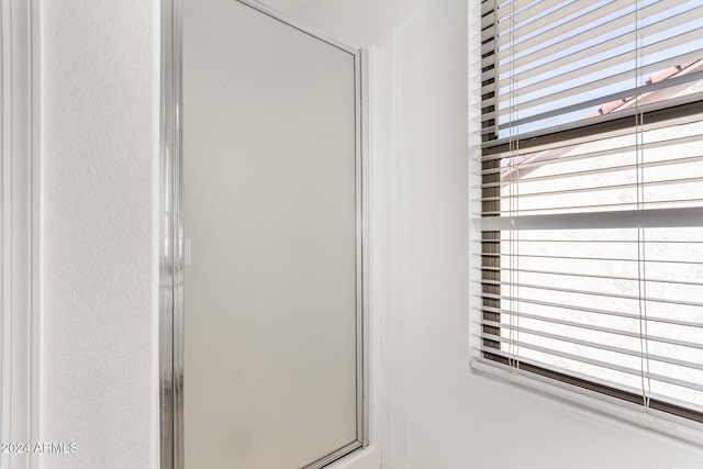 bathroom with a shower with door