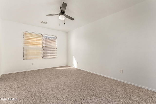 unfurnished room featuring ceiling fan and carpet floors