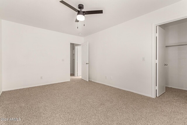 unfurnished bedroom featuring carpet flooring, ceiling fan, and a closet