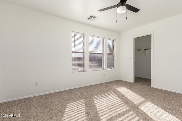 unfurnished bedroom with ceiling fan, light carpet, and a closet