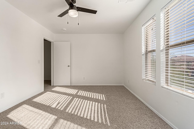 spare room with carpet flooring and ceiling fan