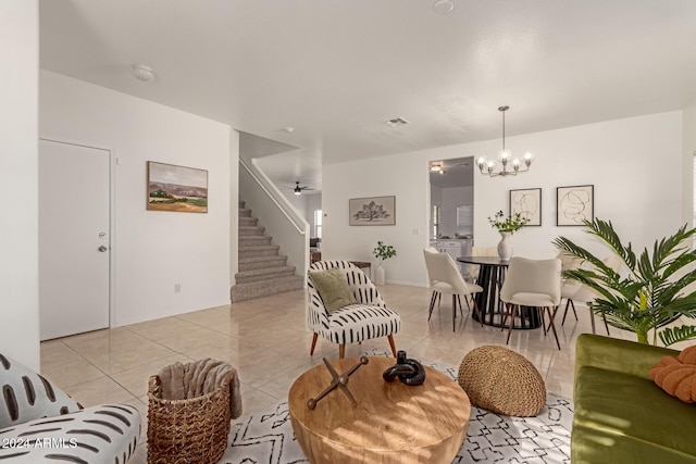 living room featuring light tile patterned floors and ceiling fan with notable chandelier