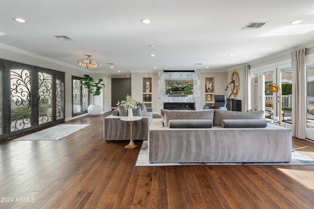 living room with crown molding, dark wood-type flooring, and french doors