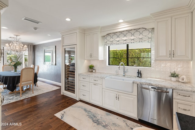 kitchen featuring backsplash, dark wood-type flooring, sink, crown molding, and stainless steel dishwasher