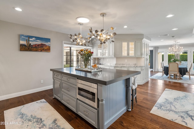 kitchen featuring white cabinetry, plenty of natural light, a kitchen island, and dark hardwood / wood-style floors