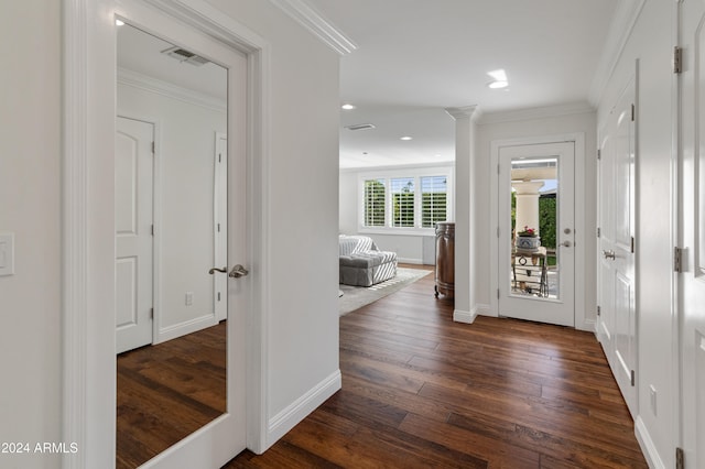 hallway featuring dark hardwood / wood-style floors and crown molding