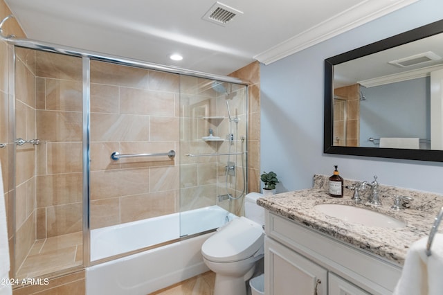 full bathroom with combined bath / shower with glass door, ornamental molding, vanity, tile patterned flooring, and toilet