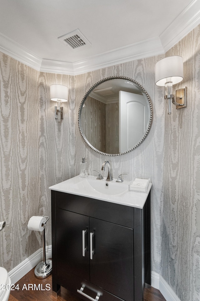 bathroom with wood-type flooring, vanity, and ornamental molding