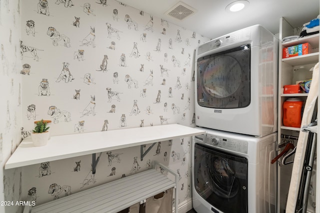 clothes washing area with stacked washer and clothes dryer