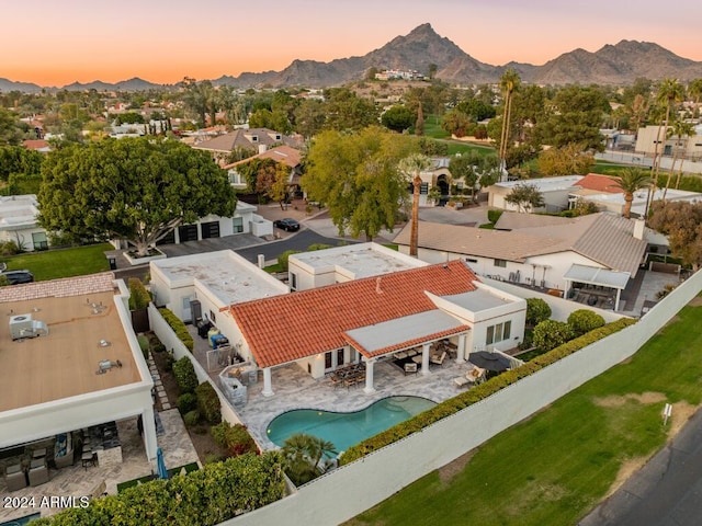 aerial view at dusk featuring a mountain view