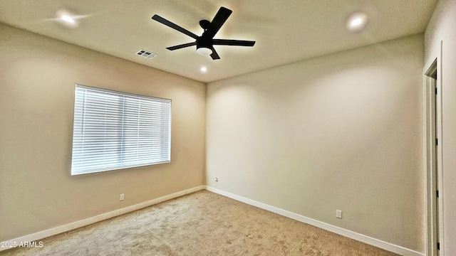 unfurnished room with light carpet and ceiling fan