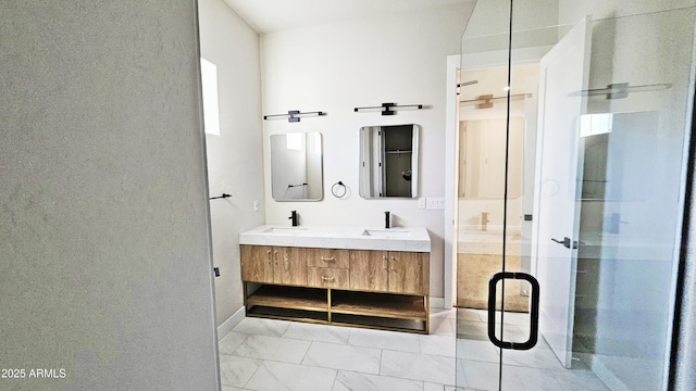 bathroom featuring vanity and a shower with shower door