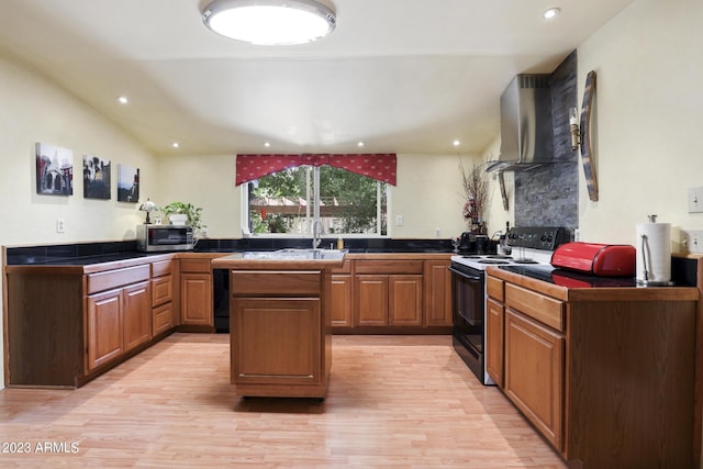 kitchen with tile countertops, range with electric cooktop, stainless steel microwave, wall chimney range hood, and light wood-type flooring