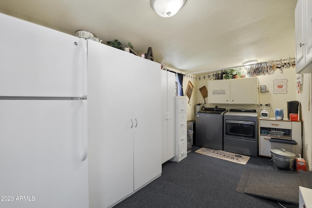 kitchen featuring washer and dryer and white cabinetry